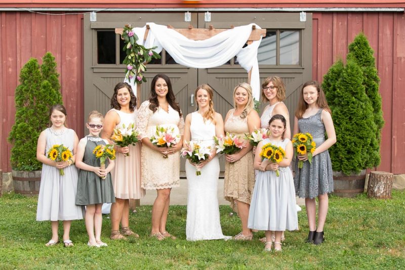 Bridesmaids and bride in front of the barn on her wedding day