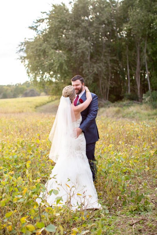 Bride and groom in field at the kent manor inn